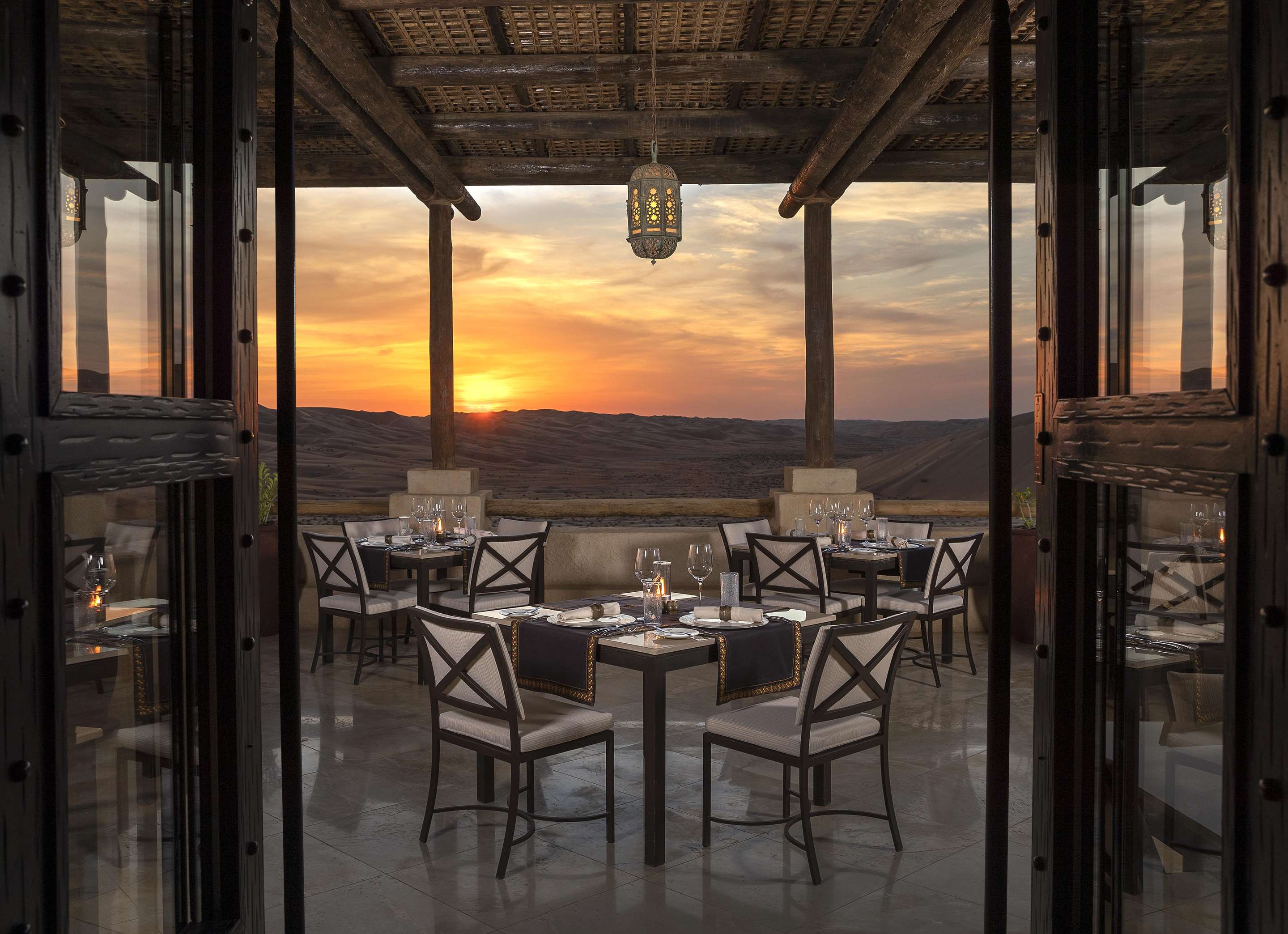 Outdoor seating set-up on terrace at Suhail Restaurant at sunset