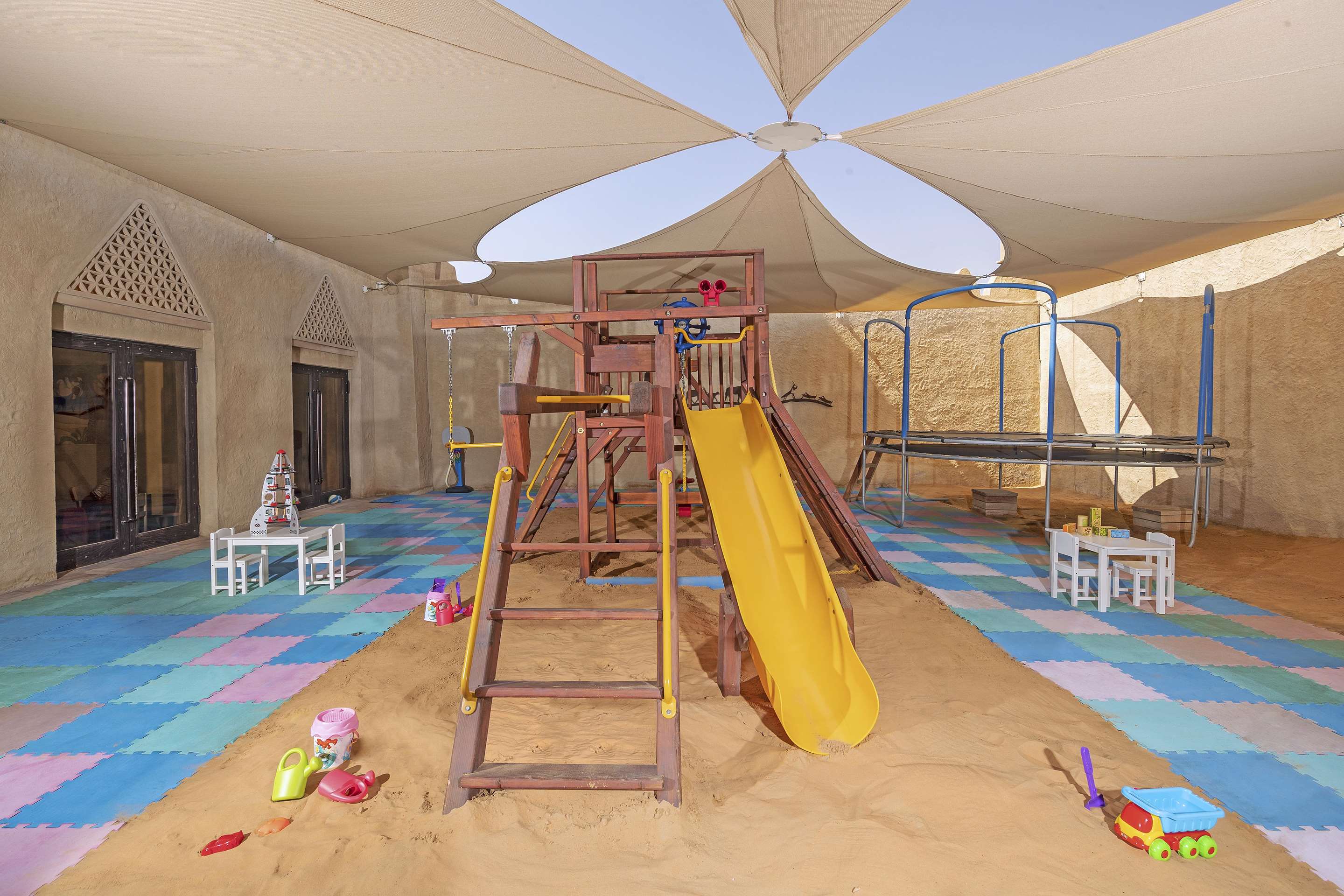 Interior view of kids playground area with equipment and toys