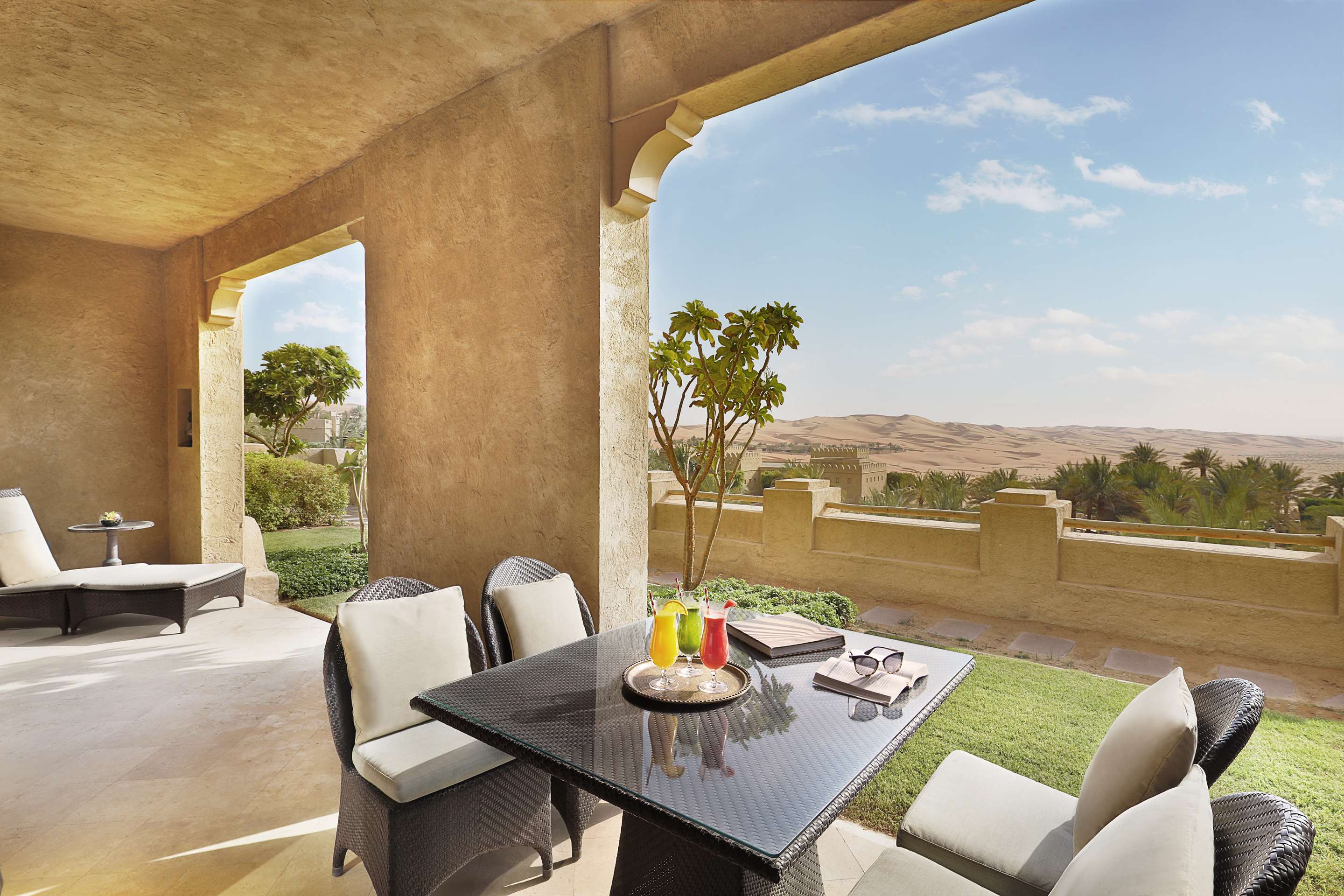 Exterior view of outdoor dining table setup on Anantara Suite terrace with desert view