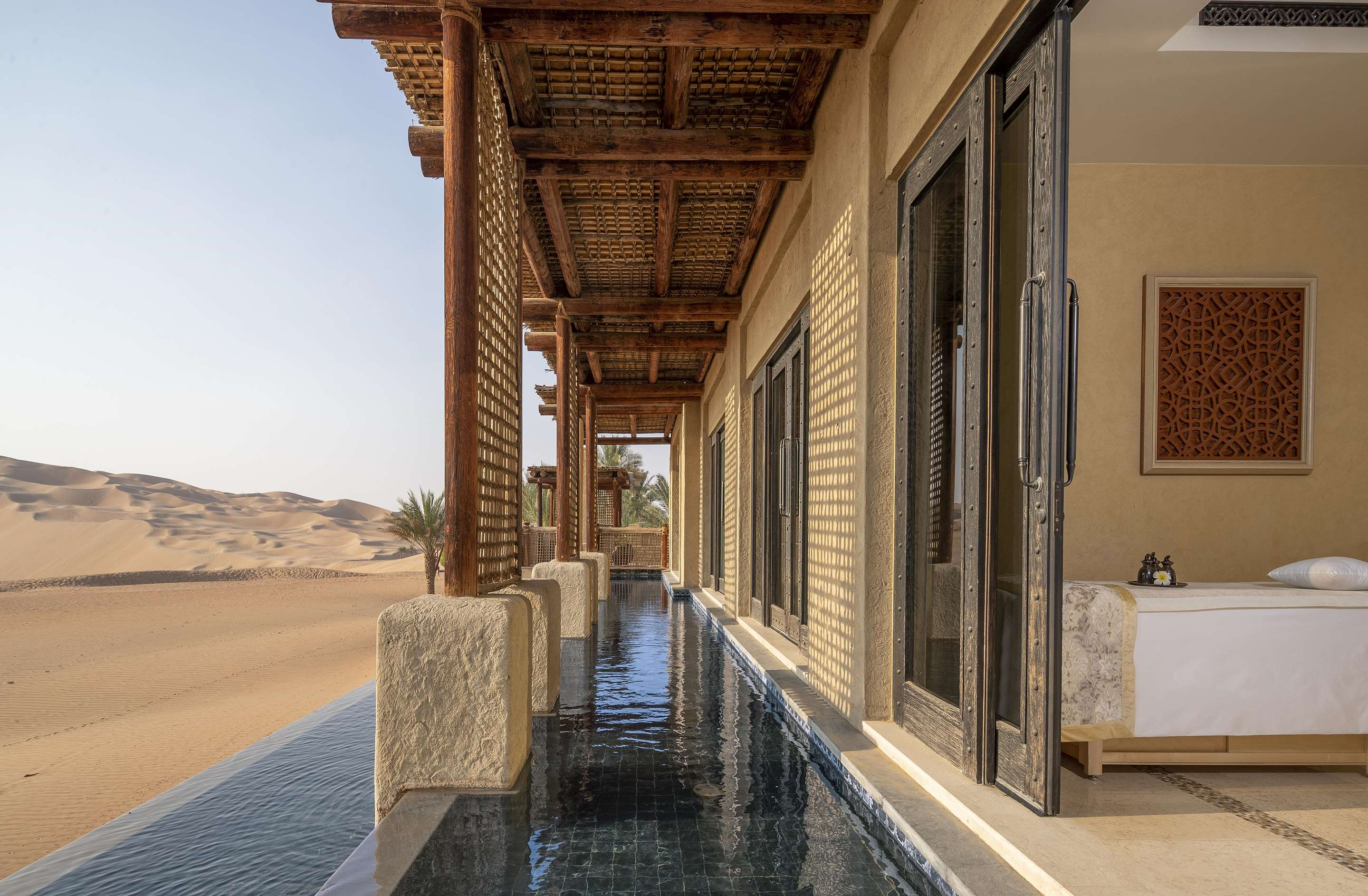 Exterior view of spa treatment room and pool with desert view