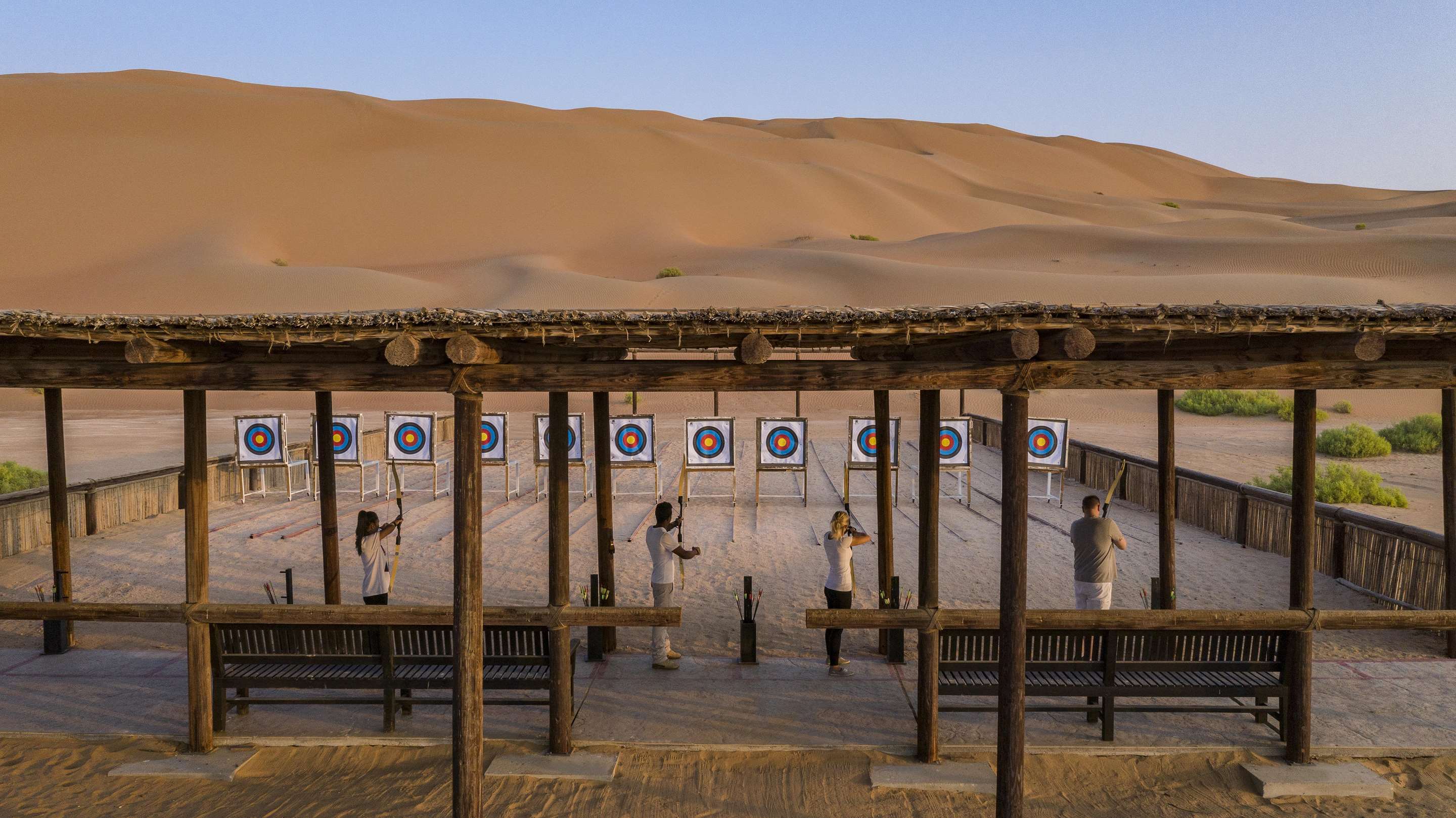 Exterior view of archery area in the desert with guests