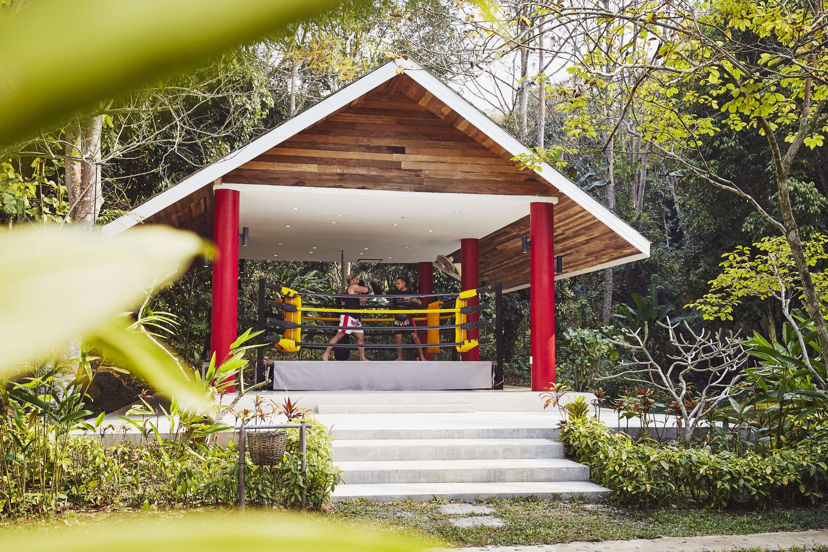 Exterior view of male guest taking Thai boxing class with instructor
